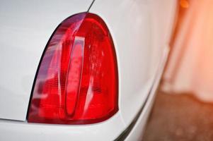 Red back headlight of white luxury limousine car. photo