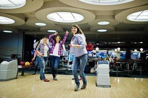 Group of girls having fun and play bowling at hen party. photo