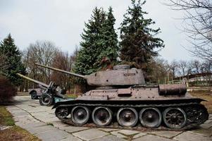 Old vintage military tank in the city pedestal. photo