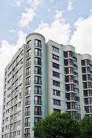 Balcony of new modern turquoise multi storey residential building house in residential area on sunny blue sky. photo