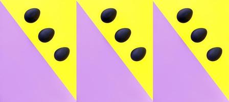 Black eggs on the yellow and violet background. Easter, diversity, geometric, pattern, food concept photo