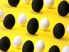 Black and white eggs on the yellow background. photo