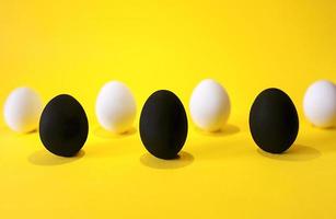 Black and white eggs on the yellow background. photo