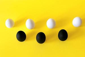 Black and white eggs on the yellow background. photo