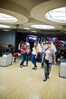 Group of girls having fun and play bowling at hen party. photo