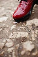 Leg of girl with extinguished cigarette on ground. Stop smoking social problem. photo