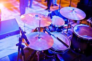 Drum set at stage on violet lights. photo