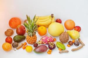 Exotic fruits isolated on white background. Healthy eating dieting food. Pitahaya, carambola, papaya, baby pineapple, mango, passion fruit, tamarind and other. photo