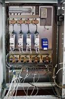 Electrical panel, electric meter and circuit breakers. Electric frequency converter, motor speed controller, rework station. photo