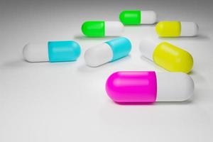 full color capsules medication on white background photo