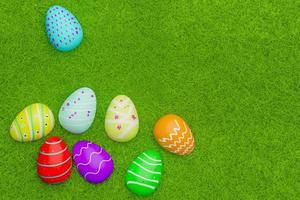 top view of full  color  easter eggs on grass field