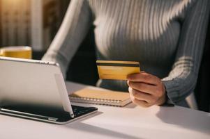 Business woman hands using smartphone and holding credit card with digital layer effect diagram as Online shopping photo