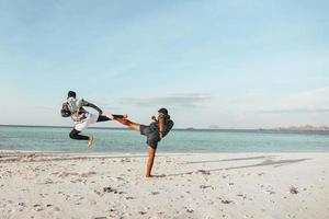 Two fighters training on the beach photo