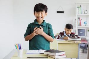 An Asian student stands up and introduces himself in class photo