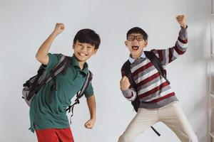 Two Asian schoolboy excited to welcoming back to school season after pandemic photo