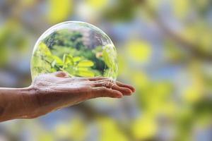 Hand of man hold bubble soap suds on palm isolated on blurred background with clipping path. photo