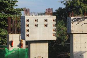 Reinforced concrete columns with dowel bars cover for future expansion. photo