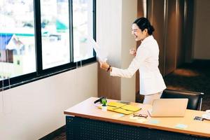 Happy office business asian woman stretching arm and joy about work. photo