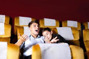 Caucasian man and woman business couple go to the cinema