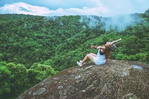 Asian woman travel nature. Travel relax. on the cliff rocks. Thailand photo