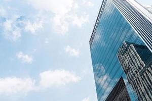 perspective background abstract building central business district construction with blue sky reflection mirror of the tall building photo