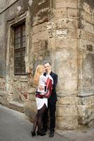 An adult married couple walks the streets of the old city. Tourism concept. photo