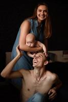 Young parents have fun with their little son photo