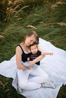 Mom and baby cuddle on a plaid photo