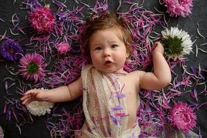 Portrait of little baby girl in white vintage home with flowers photo