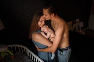 Young parents have fun with their little son photo