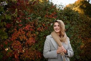 Portrait of a beautiful autumn woman. Girl posing to the camera. photo