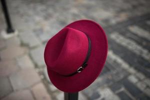 Red ladies hat on a pillar photo