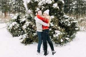 Happy Couple Having Fun Outdoors in Snow Park. Winter Vacation photo