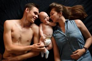 Young parents have fun with their little son photo