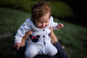 Young father having fun with his little daughter in park photo