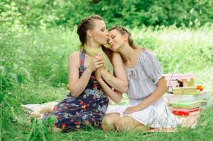 Mother and daughter hug and twisted hands. Mother kisses daughter on the forehead. photo