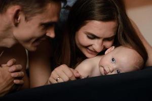 Young parents have fun with their little son photo