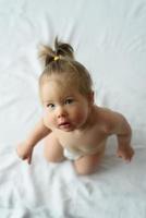 little girl sitting on a white background. Frame shot from high point photo