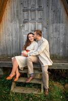 Young couple in love holding hands and walking through a park on a sunny autumn day photo