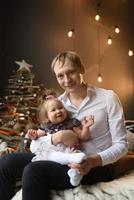 Father and his daughter have fun together before Christmas. photo