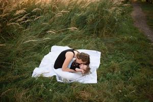 Mom and baby cuddle on a plaid photo