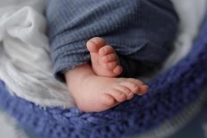 Feet newborn boy. Shot from close range. photo