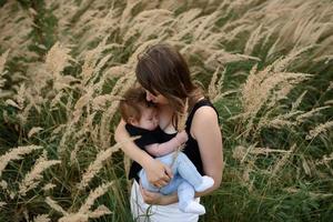 Young mother hugging cute baby outdoor photo