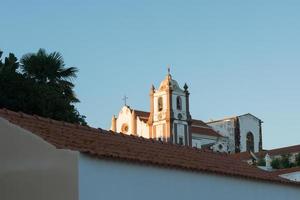 Traditional church at Silves, Portugal. White building with tower bell. photo