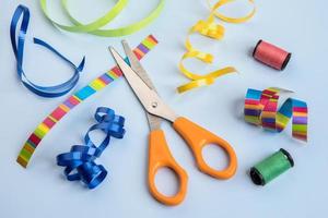 Craft objects such as scissors, ribbon, and thread.