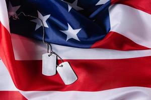 American flag and military dog tags close-up. photo