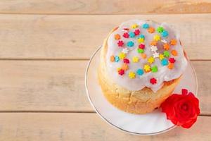 Easter cake with sweet icing on a wooden background. photo