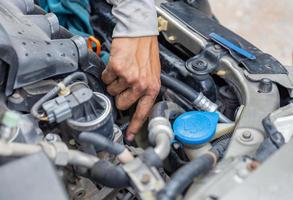 Selective focus of Mechanic fixing cooling water pipe at car engine, Car repair concept