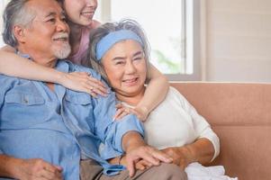 Asian family sitting in living room, Senior father mother and middle aged daughter, Happiness family concepts photo