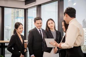 Success and Teamwork concept, Group of young business people meeting in office photo